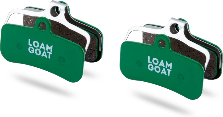 A pair of Loam Goat Gravity pads with green backplates